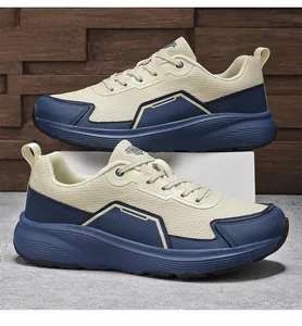 Detail of wide-toe running shoe featuring beige mesh and navy blue synthetic overlays