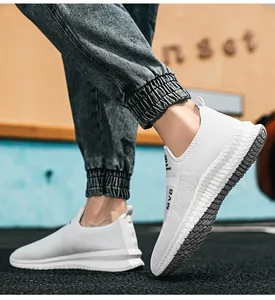 Low-angle shot of white breathable mesh slip-on sneakers for men with MVB logo details