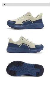 Detailed view of wide-toe athletic shoes with beige mesh uppers and blue cushioned soles
