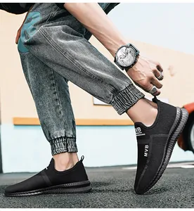Detailed macro view of breathable black mesh material and MVB logo on men's sport sneakers