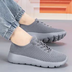 Grey breathable mesh athletic sneakers with cushioned non-slip soles for men and women
