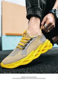 Detail of yellow knit running shoes featuring wavy hollowed-out soles and breathable mesh
