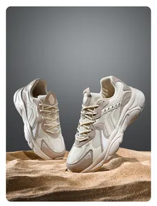 Detailed macro view of beige chunky sneakers with mesh and suede texture on sand background