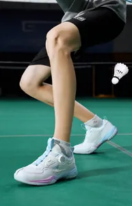 Close-up of breathable mesh badminton shoe with quick-dial lacing and silver accents