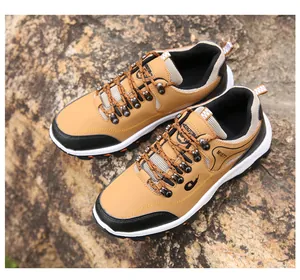 Detail of camel leather hiking boots with metal eyelets and durable braided laces