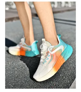 Detail of colorful gradient mesh sneakers with rotary lace system on asphalt road