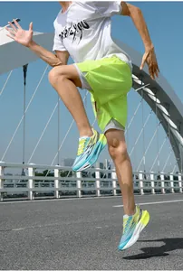 Dynamic shot of gradient running shoes with breathable mesh and cushioning sole on a white bridge