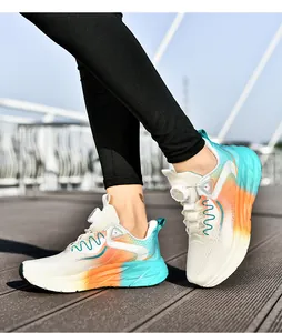 Detail of running shoes with gradient orange blue colors and twist buckle lacing system