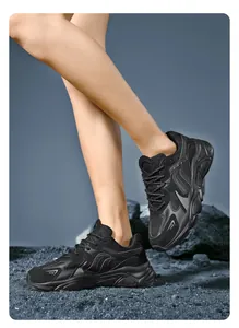 Side view detail of black chunky dad sneakers with mesh and synthetic leather texture