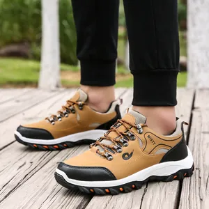 Outdoor hiking shoes in brown and black synthetic leather on a wooden boardwalk