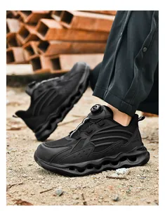 Outdoor shot of safety shoes with wave-shaped shock-absorbing soles on gravel ground