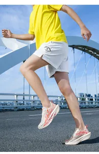 Close-up of white breathable mesh shorts and yellow t-shirt for outdoor running style