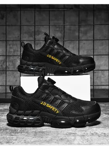 Detailed macro view of black safety shoes with breathable mesh and quick-dial lacing system