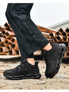 Detail of black safety shoe with rotary dial lacing and wave-pattern cushioning sole