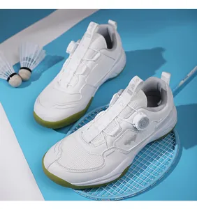Detail of breathable mesh upper and quick-lace rotary knob on white badminton shoes