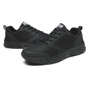 Detail view of breathable black mesh sneakers with textured synthetic support and thick sole
