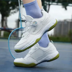 Breathable badminton shoes with quick knob lacing system and green non-slip gum rubber soles