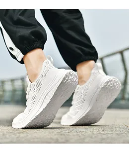 Close-up of white breathable fly-knit mesh fabric and durable non-slip sole on men sneakers