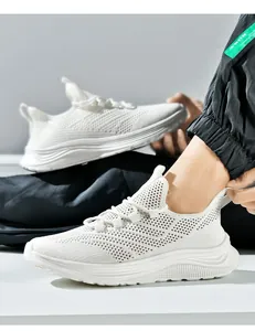 Detail of white fly-knit breathable mesh fabric and thick shock-absorbing sole of running shoes