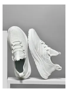 Detailed macro view of white breathable knit fabric and thick cushioned midsole of sneakers