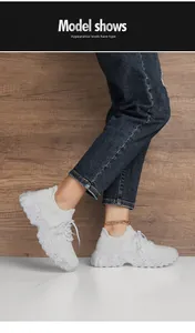 Detail of white breathable mesh sneakers with platform textured sole on model