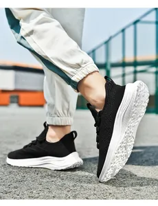 Macro shot of breathable fly-knit mesh and flexible white sole of a black running shoe