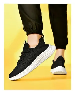 Detail of black breathable knit sneakers with thick white shock-absorbing soles