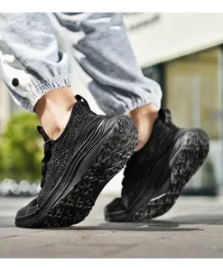 Close-up of black breathable mesh texture and non-slip rubber sole on men's running shoes