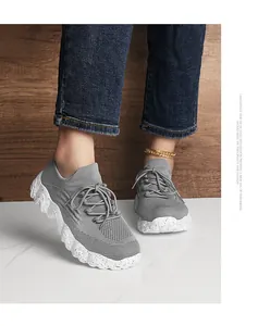 Detail of gray breathable mesh sneakers featuring a speckled platform sole and lace-up knit design