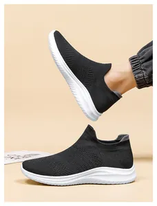 Detail of black knit walking shoes with breathable upper and thick white wavy sole