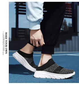 Detail of breathable black mesh slip-on sneakers worn outdoors for a sporty look