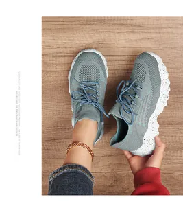 Detail view of breathable grey-blue knit mesh upper with wavy speckled thick white sole