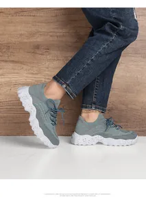 Close-up of breathable knit mesh fabric and wave-shaped speckled sole on blue sneaker