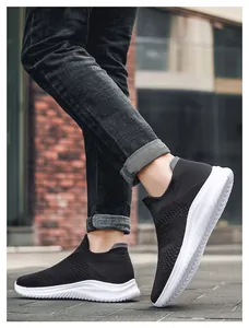 Close-up of black breathable knit upper and white anti-slip thick sole on a walking shoe
