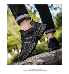 Men's outdoor hiking shoe with black breathable mesh and rugged sole on rocky terrain