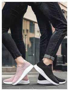 Close-up of knit breathable mesh sneakers in pink and black on outdoor street