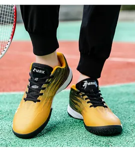 Close-up of vibrant yellow badminton shoes with MRK logo on a professional court