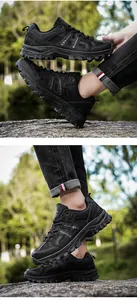 Detail of all-black hiking shoes with thick non-slip rubber soles on rocky outdoor terrain