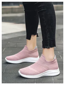Detail of pink knitted slip-on sneakers with white wavy thick soles and ribbed collars