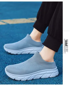 Detail of light blue mesh slip-on sports mule on track with breathable knit fabric