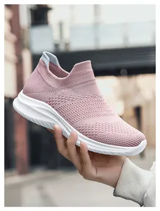 Pink knit slip-on walking shoe featuring breathable honeycomb texture and white cushioned sole