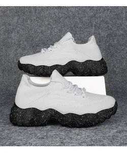 Detail of white breathable knit upper and thick speckled black wave sole on casual shoes