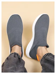 Detailed top-down view of grey knit slip-on sneakers with white cushioned soles for men