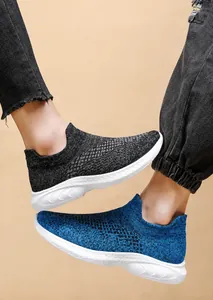 Detail view of breathable knit mesh fabric and lightweight soles on walking shoes