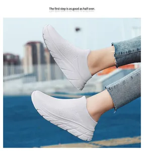 Outdoor shot of white breathable knit running shoe with lightweight slip-on design