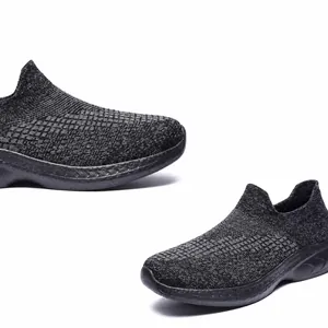 Detail view of breathable fly-knit mesh fabric and slip-on design for grey casual sneakers
