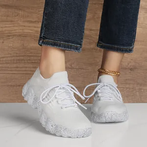 Women's breathable white knitted sneakers with speckled platform soles on models feet