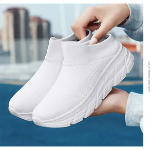 Close-up of white breathable fly-knit slip-on sneaker with thick cushioned wave sole