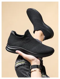 Detail of black knit sock sneaker showing breathable mesh texture and elastic cuff