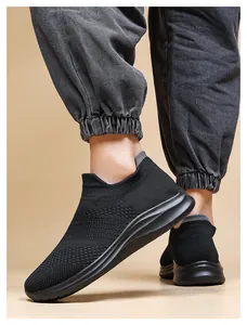 Close-up of black breathable mesh sneaker featuring elastic knit upper and cushioned sole